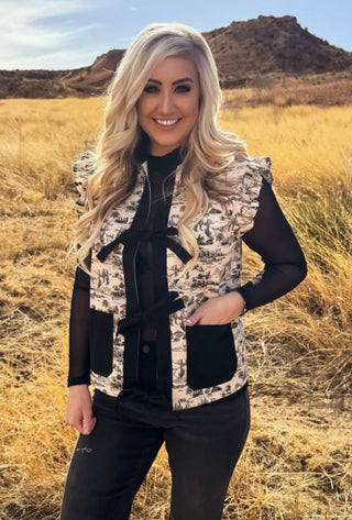 Woman wearing a western patterned vest in a desert landscape